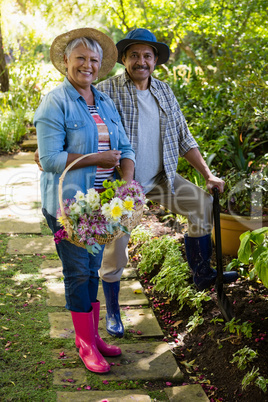 Senior couple standing in garden on a sunny day