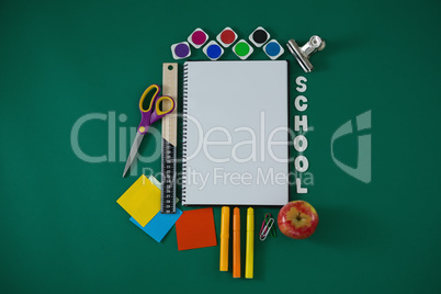 School supplies with text arranged on green background