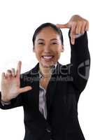 Portrait of smiling businesswoman doing finger frame gesture