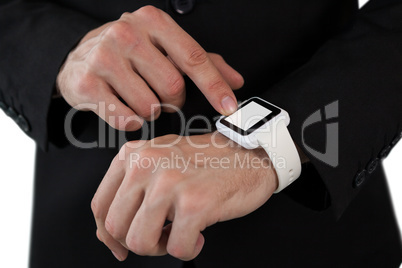 Mid section of businessman touching smart watch