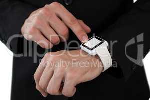 Mid section of businessman touching smart watch