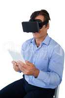High angle view of businessman with tablet using vr glasses
