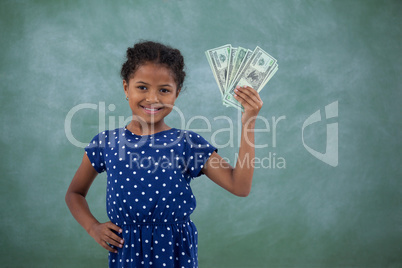 Smiling girl with hand on hip showing paper currency