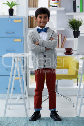 Full length portrait of businessman with arms crossed