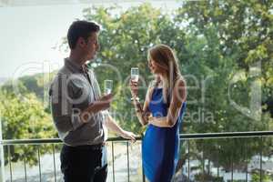 Couple interacting with each other while having champagne