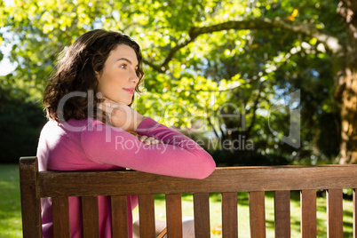 Woman sitting on bench in garden