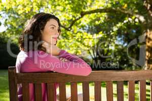 Woman sitting on bench in garden