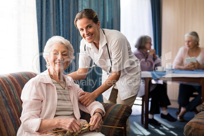 Portrait of smiling female doctor with senior woman