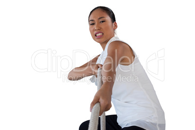 Portrait of woman clenching teeth while pulling rope
