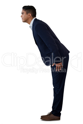Side view of businessman bowing while standing