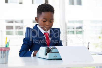 Businessman using typewriter at desk