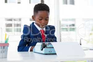 Businessman using typewriter at desk