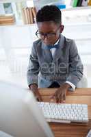 High angle view of businessman wearing eyeglasses using computer