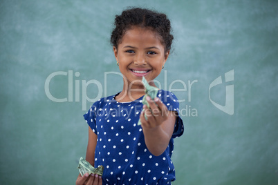Portrait of girl giving paper currency