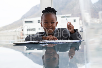 Smiling businesswoman with document looking away