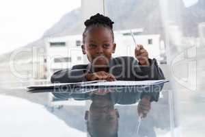 Smiling businesswoman with document looking away