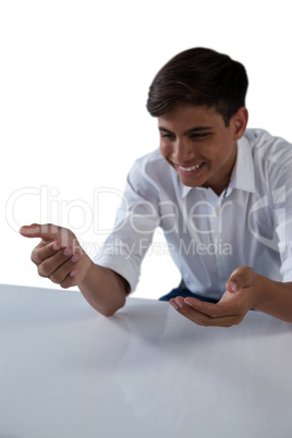 Teenage boy pretending to work on an invisible object