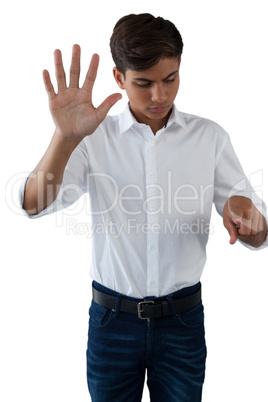 Teenage boy pressing an invisible virtual screen