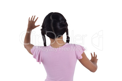 Girl pretending to touch an invisible screen against white background