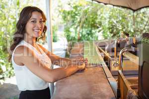 Portrait of woman standing at counter