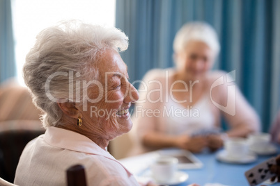 Happy senior woman sitting with friends