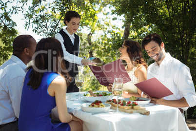 Friends placing order to waiter