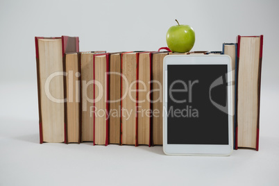 Apple, digital tablet and books on white background
