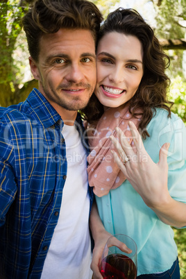 Portrait of romantic couple holding glass of red wine