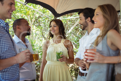 Friends interacting while having a alcohol at counter