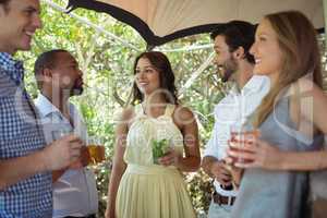 Friends interacting while having a alcohol at counter