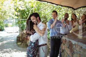 Friends embracing each other at counter