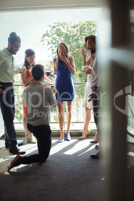 Man proposing woman with engagement ring