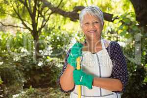 Senior woman standing in garden on a sunny day