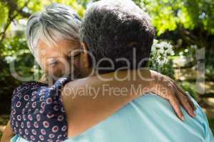 Senior man giving flowers to woman