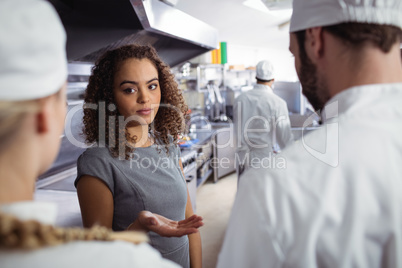 Restaurant manager interacting with his kitchen staff