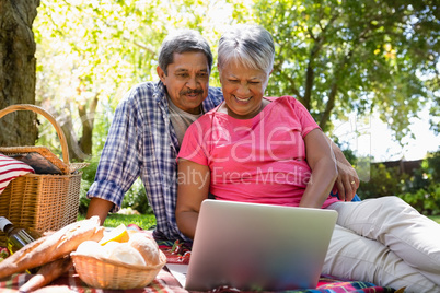 Senior couple using laptop