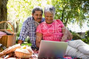 Senior couple using laptop