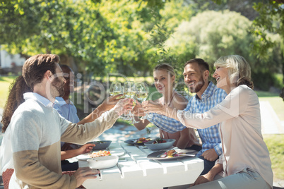 Group of friends toasting glasses of wine in a restaurant