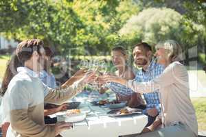 Group of friends toasting glasses of wine in a restaurant