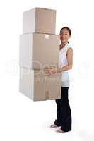 Portrait of businesswoman carrying stack of cardboard boxes