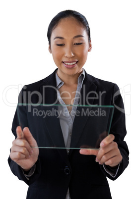 Young businesswoman holding glass interface