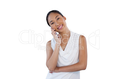 Happy businesswoman with head cocked talking on mobile phone