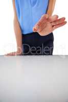 Businesswoman showing something standing by table