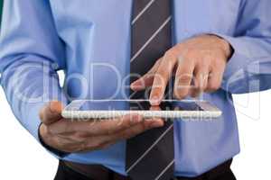 Mid section of businessman using tablet