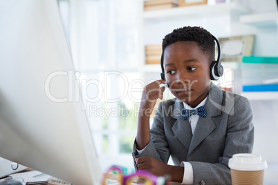 Businessman wearing headphone while working