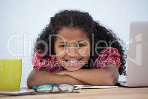 Portrait of smiling businesswoman leaning on desk