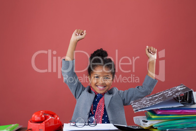 Portrait of smiling businesswoman with arms raised