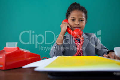 Portrait of businesswoman talking on land line phone