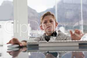 Serious businessman using keyboard at table