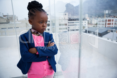 Serious thoughtful businesswoman standing with arms crossed